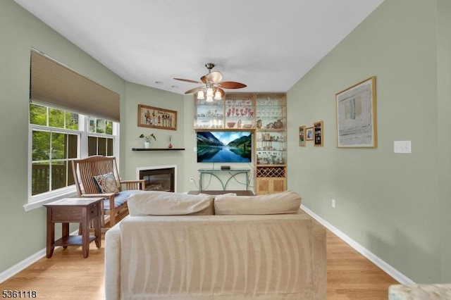 42 Rockcreek Ter Unit 42, Riverdale Boro, NJ 07457 - living room featuring ceiling fan, light wood finished floors, a glass covered fireplace, and baseboards