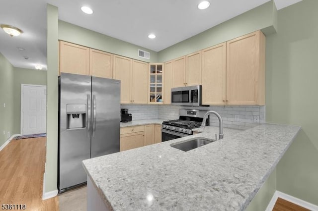 42 Rockcreek Ter Unit 42, Riverdale Boro, NJ 07457 - kitchen with stainless steel appliances, light brown cabinets, a peninsula, glass insert cabinets, and recessed lighting