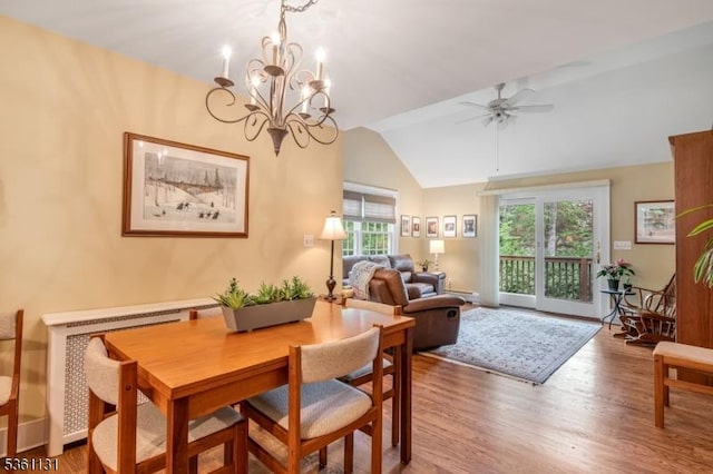 498 Pines Lake Dr, Wayne Twp, NJ 07470 - dining room featuring wood finished floors, vaulted ceiling, ceiling fan, and a chandelier
