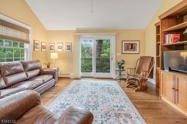 498 Pines Lake Dr, Wayne Twp, NJ 07470 - living room with vaulted ceiling, a baseboard heating unit, and light wood-type flooring