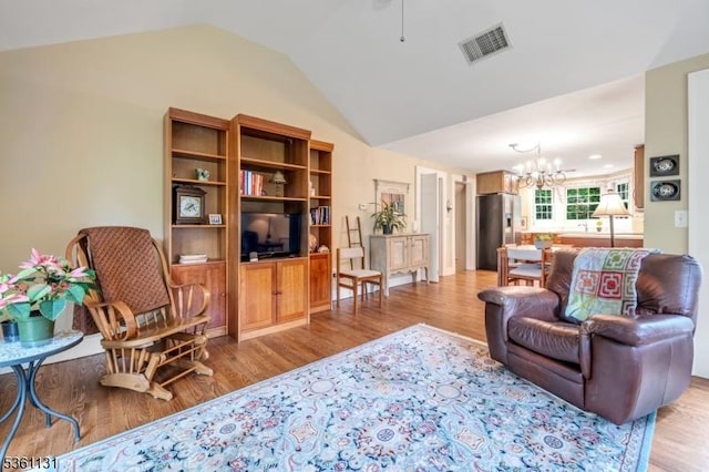 498 Pines Lake Dr, Wayne Twp, NJ 07470 - living area with a chandelier, lofted ceiling, light wood-type flooring, and ceiling fan