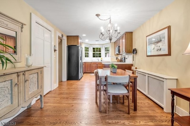 498 Pines Lake Dr, Wayne Twp, NJ 07470 - dining room featuring a chandelier, light wood-style floors, and recessed lighting
