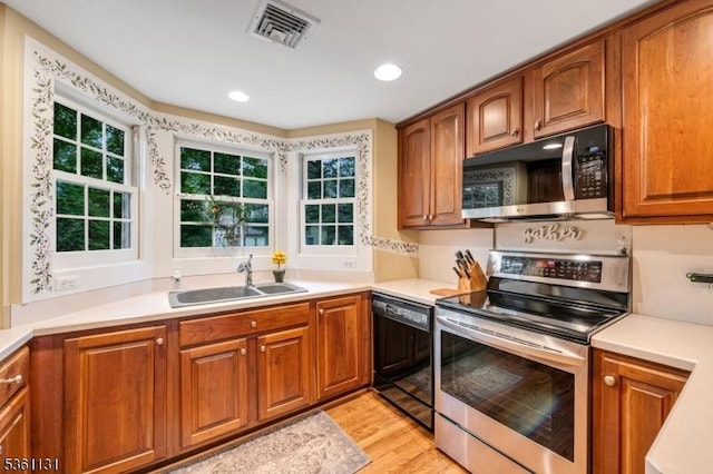 498 Pines Lake Dr, Wayne Twp, NJ 07470 - kitchen with electric range, dishwasher, a sink, brown cabinets, and light wood-type flooring