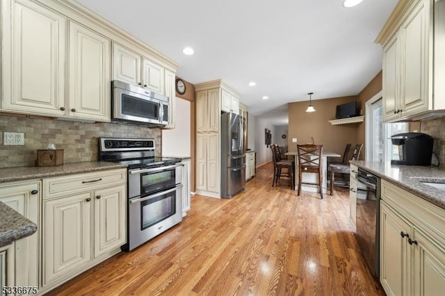 6 Cambridge Ct, Mount Olive Twp, NJ 07828 - kitchen with stainless steel appliances, cream cabinetry, light wood-type flooring, decorative backsplash, and decorative light fixtures