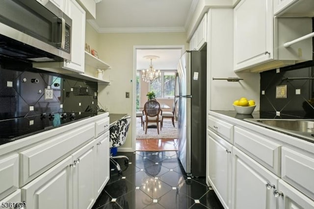 10 Smith Manor Blvd Unit 514, West Orange Twp, NJ 07052 - kitchen with stainless steel appliances, crown molding, a chandelier, white cabinetry, and dark tile patterned floors