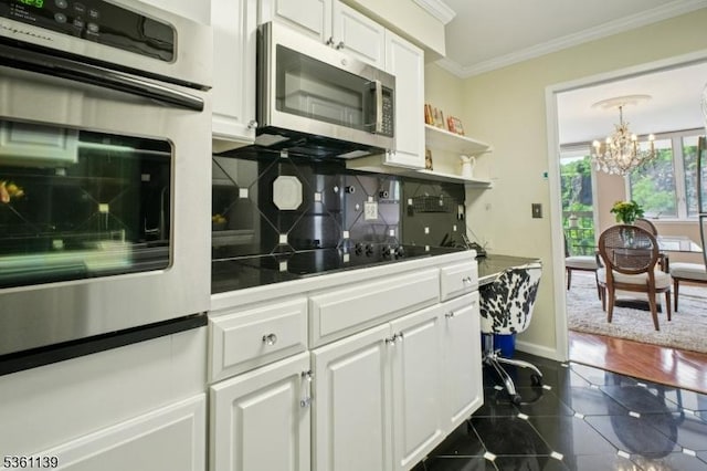 10 Smith Manor Blvd Unit 514, West Orange Twp, NJ 07052 - kitchen with stainless steel appliances, a chandelier, white cabinets, crown molding, and decorative backsplash