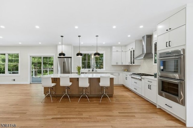 48 Hunterdon Blvd, Berkeley Heights Twp, NJ 07974 - kitchen featuring wall chimney range hood, appliances with stainless steel finishes, plenty of natural light, light wood-style flooring, and recessed lighting