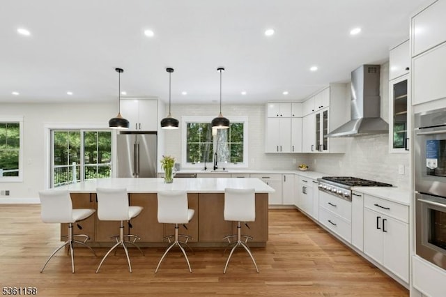 48 Hunterdon Blvd, Berkeley Heights Twp, NJ 07974 - kitchen with wall chimney exhaust hood, appliances with stainless steel finishes, a kitchen island, healthy amount of natural light, and recessed lighting