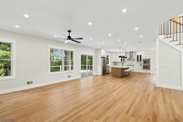 48 Hunterdon Blvd, Berkeley Heights Twp, NJ 07974 - living room with recessed lighting, light wood finished floors, a ceiling fan, healthy amount of natural light, and stairway