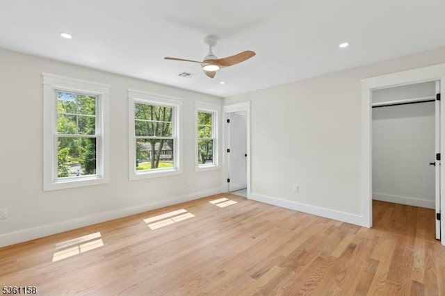 48 Hunterdon Blvd, Berkeley Heights Twp, NJ 07974 - unfurnished bedroom featuring multiple windows, light wood-style floors, a spacious closet, a ceiling fan, and recessed lighting