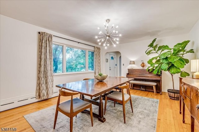 720 Valley St, Maplewood Twp, NJ 07040 - dining room featuring arched walkways, a chandelier, light wood-type flooring, and baseboard heating