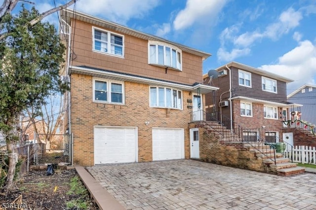 514 E Elm St, Linden City, NJ 07036 - view of front facade featuring brick siding, decorative driveway, and an attached garage