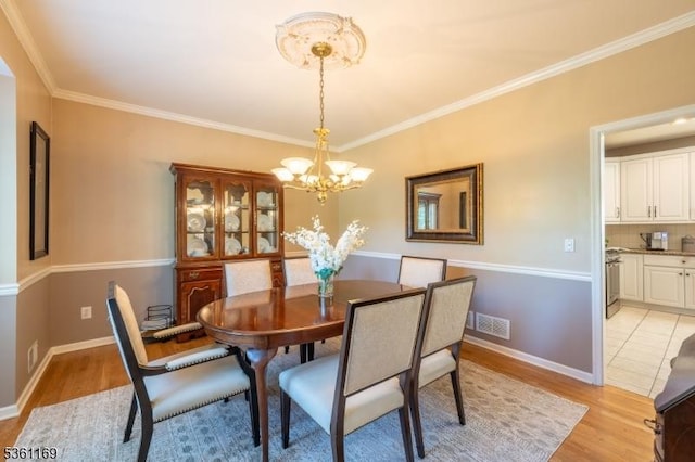 27 Horseshoe Dr, Hillsborough Twp, NJ 08844 - dining space featuring light wood-style floors, a chandelier, and ornamental molding