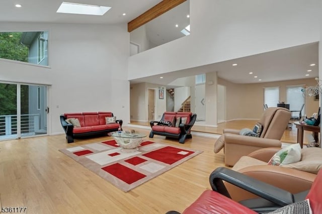 12 Fox Hollow Rd, Montville Twp, NJ 07045 - living area with wood finished floors, healthy amount of natural light, a towering ceiling, stairway, and a skylight