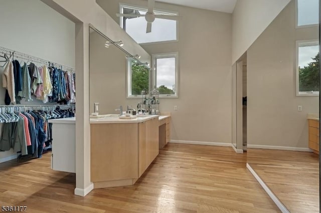 12 Fox Hollow Rd, Montville Twp, NJ 07045 - full bathroom with vanity, ceiling fan, a towering ceiling, wood finished floors, and a walk in closet