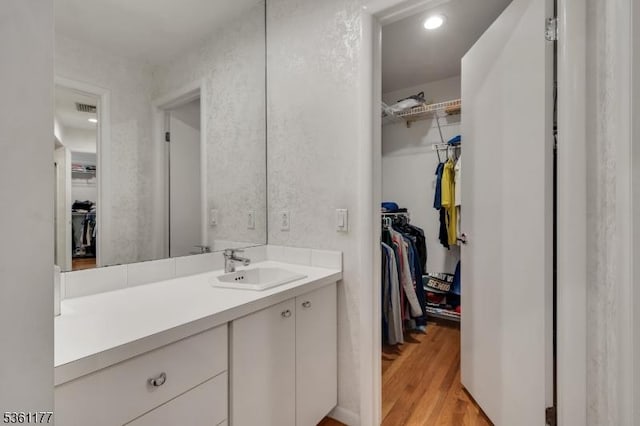 12 Fox Hollow Rd, Montville Twp, NJ 07045 - bathroom with vanity, a walk in closet, and wood finished floors