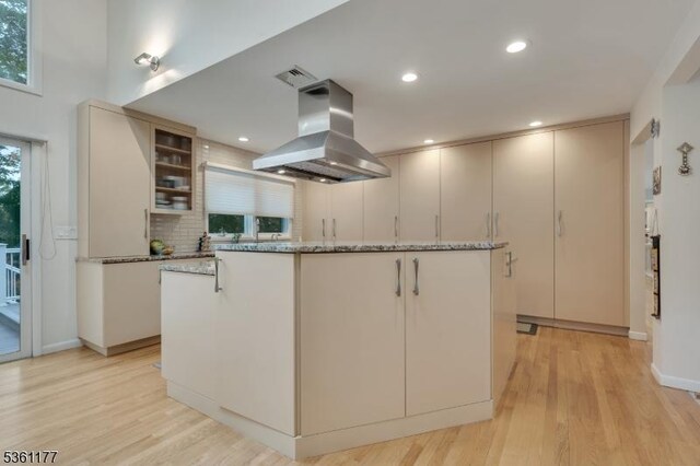 12 Fox Hollow Rd, Montville Twp, NJ 07045 - kitchen with island range hood, a kitchen island, light wood-style flooring, decorative backsplash, and recessed lighting