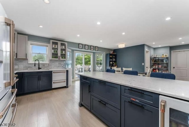 11 Spring Mdw, Oxford Twp, NJ 07863 - kitchen with beverage cooler, dishwashing machine, light wood-type flooring, recessed lighting, and glass insert cabinets