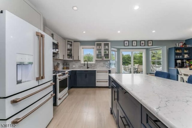 11 Spring Mdw, Oxford Twp, NJ 07863 - kitchen featuring white appliances, healthy amount of natural light, light wood finished floors, light stone countertops, and recessed lighting