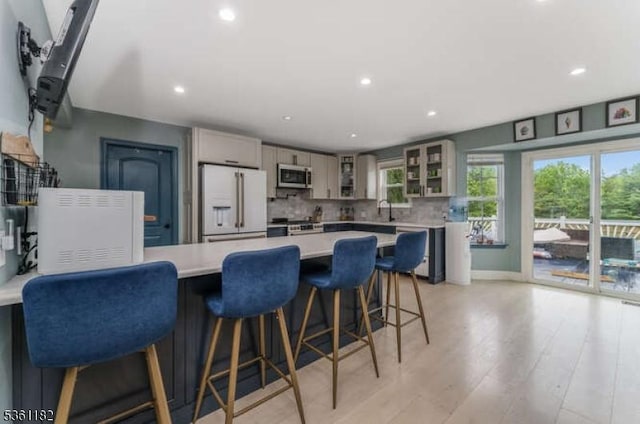 11 Spring Mdw, Oxford Twp, NJ 07863 - kitchen with appliances with stainless steel finishes, light countertops, a peninsula, glass insert cabinets, and backsplash