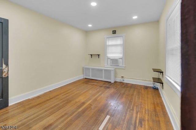 53 Elliot Pl, East Orange City, NJ 07018 - unfurnished room with radiator heating unit, wood-type flooring, baseboards, recessed lighting, and cooling unit