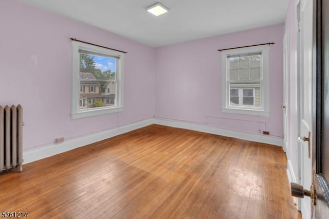 53 Elliot Pl, East Orange City, NJ 07018 - spare room with radiator heating unit, light wood finished floors, and baseboards