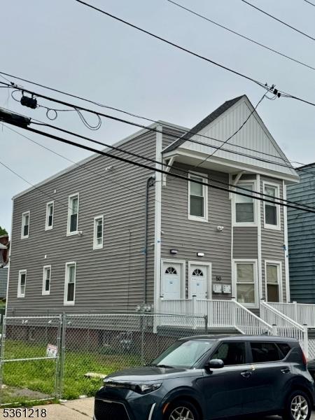 50 Willoughby St, Newark City, NJ 07112 - view of front of house featuring a fenced front yard and board and batten siding