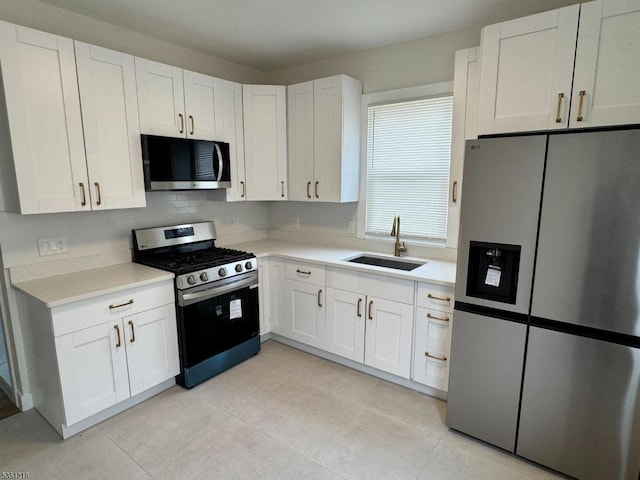 50 Willoughby St, Newark City, NJ 07112 - kitchen with stainless steel appliances, a sink, light countertops, and white cabinetry