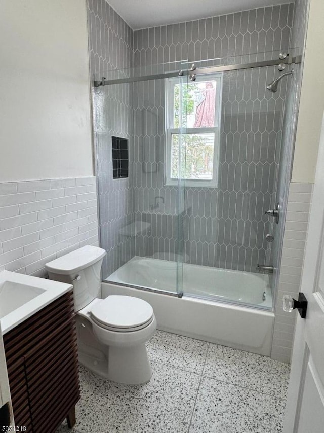 50 Willoughby St, Newark City, NJ 07112 - bathroom featuring tile walls, toilet, enclosed tub / shower combo, vanity, and wainscoting