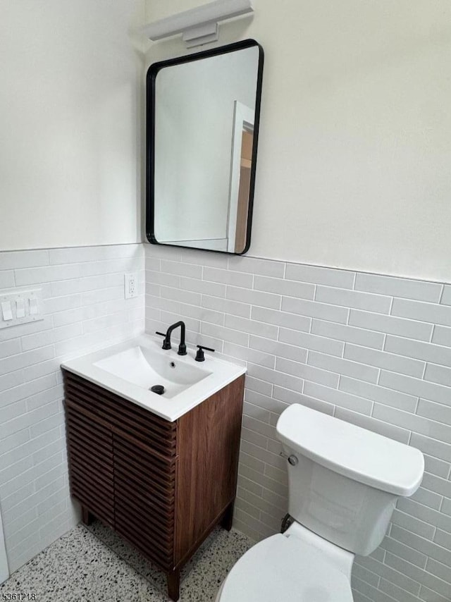 50 Willoughby St, Newark City, NJ 07112 - half bathroom featuring tile walls, vanity, toilet, and a wainscoted wall