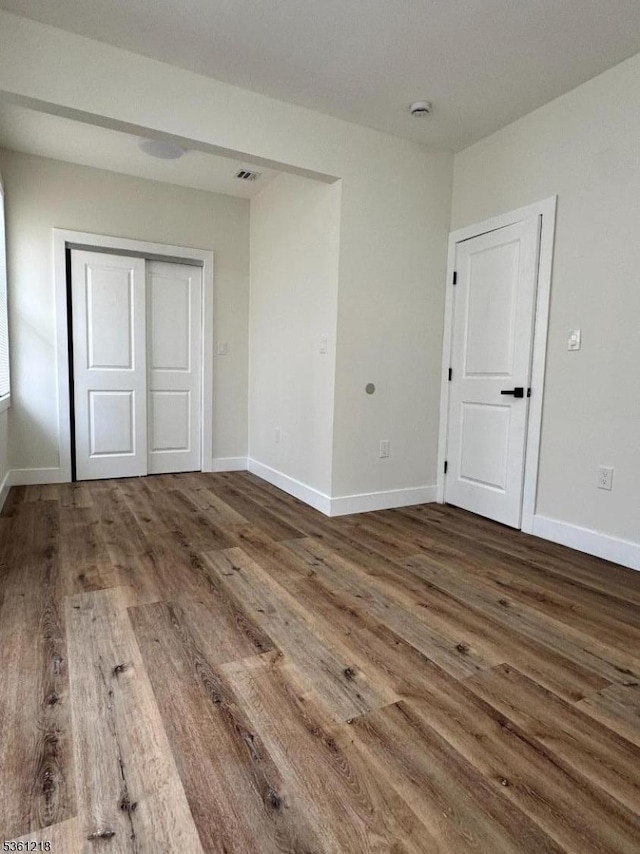 50 Willoughby St, Newark City, NJ 07112 - unfurnished bedroom featuring wood finished floors, baseboards, and a closet