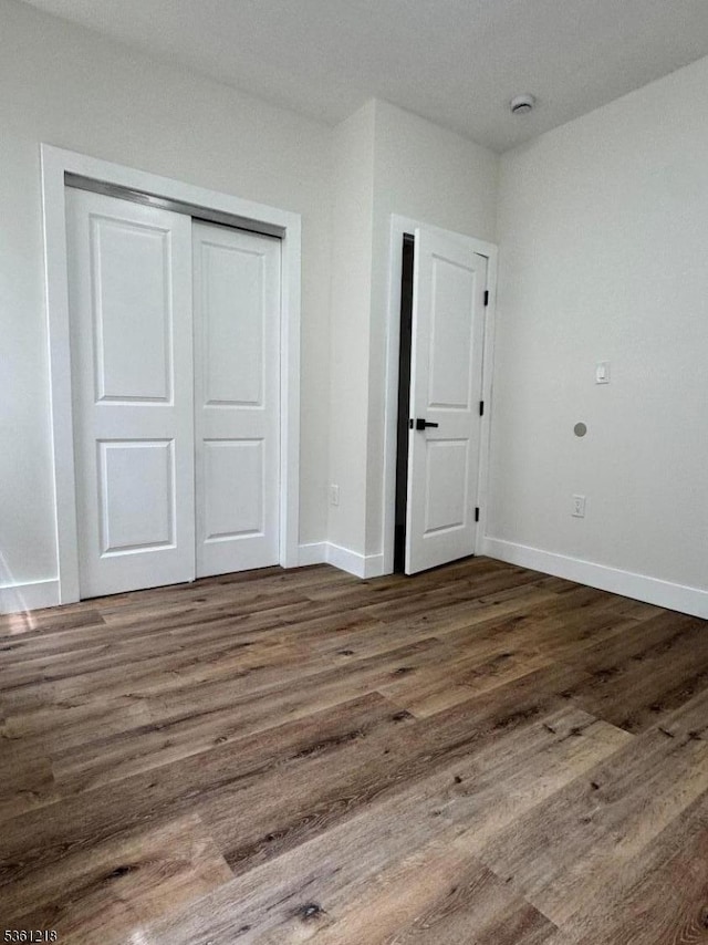 50 Willoughby St, Newark City, NJ 07112 - unfurnished bedroom with wood finished floors, a closet, and baseboards