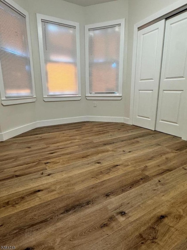 50 Willoughby St, Newark City, NJ 07112 - unfurnished bedroom with dark wood finished floors, a closet, and baseboards