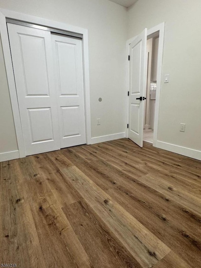 50 Willoughby St, Newark City, NJ 07112 - unfurnished bedroom with wood finished floors, baseboards, and a closet