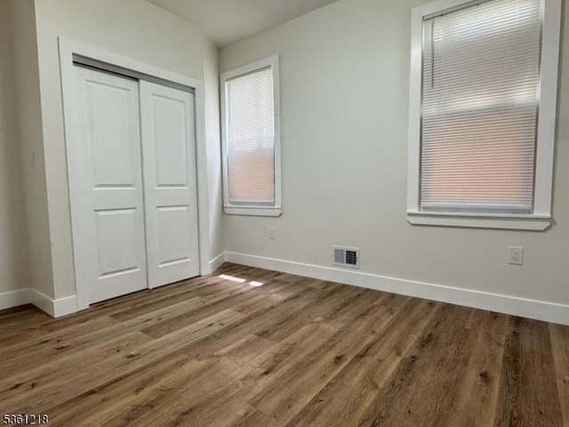 50 Willoughby St, Newark City, NJ 07112 - unfurnished bedroom featuring baseboards, a closet, and wood finished floors