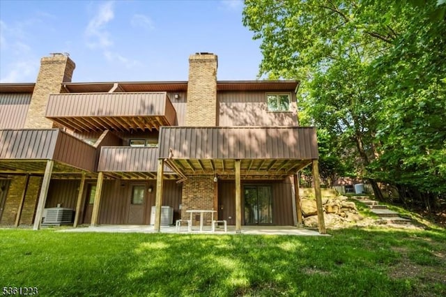 14 Highpoint Unit 14, Cedar Grove Twp, NJ 07009 - rear view of property featuring a yard, a chimney, and a patio area