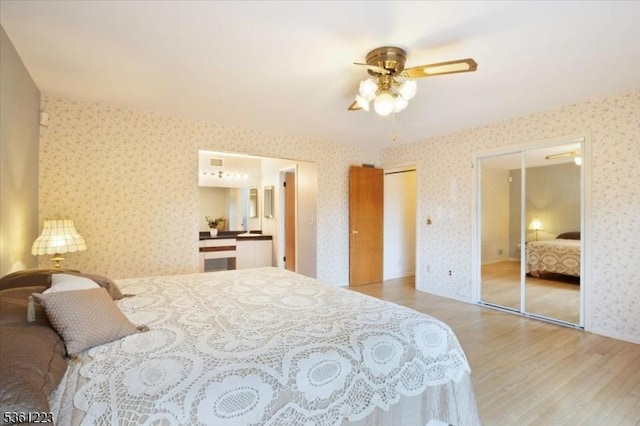 14 Highpoint Unit 14, Cedar Grove Twp, NJ 07009 - bedroom featuring wallpapered walls, wood finished floors, two closets, and a ceiling fan