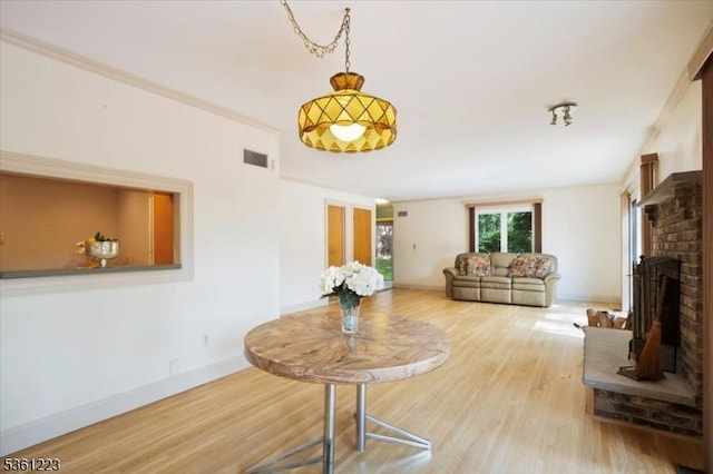 14 Highpoint Unit 14, Cedar Grove Twp, NJ 07009 - living room featuring wood finished floors, a brick fireplace, baseboards, and crown molding