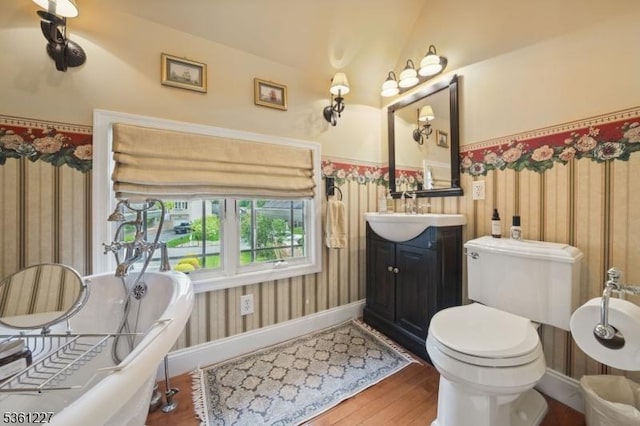 10 Fawn Ter, Jefferson Twp, NJ 07849 - bathroom featuring wood finished floors, a soaking tub, vanity, toilet, and baseboards