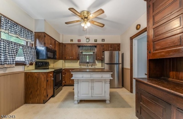 126 Park Ave, Lopatcong Twp, NJ 08865 - kitchen featuring black appliances, ceiling fan, a sink, and a kitchen island