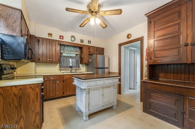 126 Park Ave, Lopatcong Twp, NJ 08865 - kitchen featuring freestanding refrigerator, a ceiling fan, black microwave, a kitchen island, and a sink