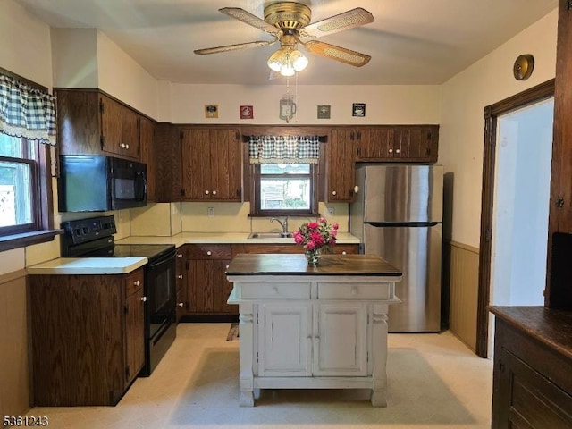 126 Park Ave, Lopatcong Twp, NJ 08865 - kitchen featuring black appliances, a sink, ceiling fan, a center island, and dark brown cabinets