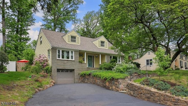 125 King St, Fanwood Boro, NJ 07023 - cape cod house featuring stone siding, asphalt driveway, and a garage