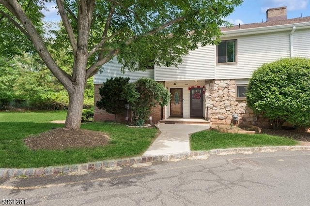 665F Dover Ct, Hillsborough Twp, NJ 08844 - view of front facade featuring a front yard, a chimney, and stone siding