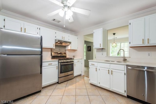 212 Riveredge Dr Unit 212, Chatham Twp, NJ 07928 - kitchen with stainless steel appliances, under cabinet range hood, a sink, light countertops, and crown molding