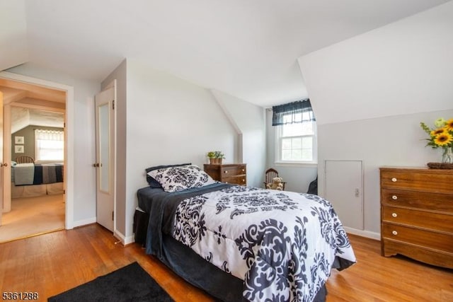 24 W Windy Bush Ln, Sparta Twp, NJ 07871 - bedroom with wood finished floors, vaulted ceiling, and baseboards