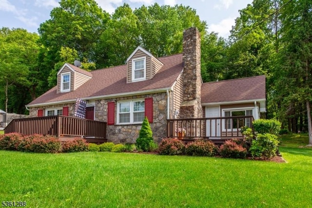 24 W Windy Bush Ln, Sparta Twp, NJ 07871 - view of front of house with stone siding, a chimney, a wooden deck, a front yard, and a shingled roof