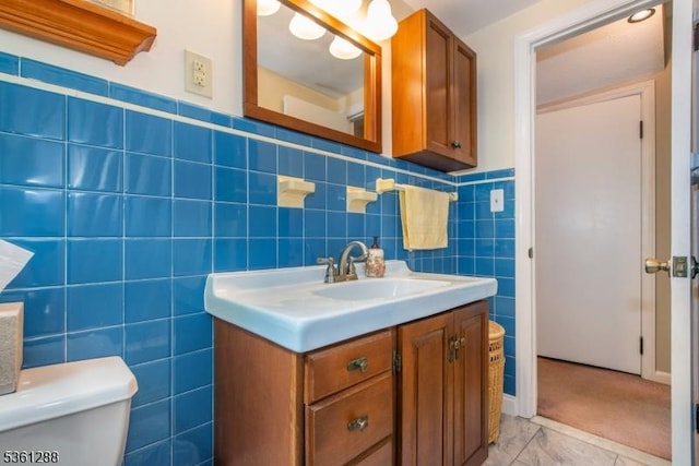 24 W Windy Bush Ln, Sparta Twp, NJ 07871 - half bath featuring vanity, tile walls, toilet, and wainscoting