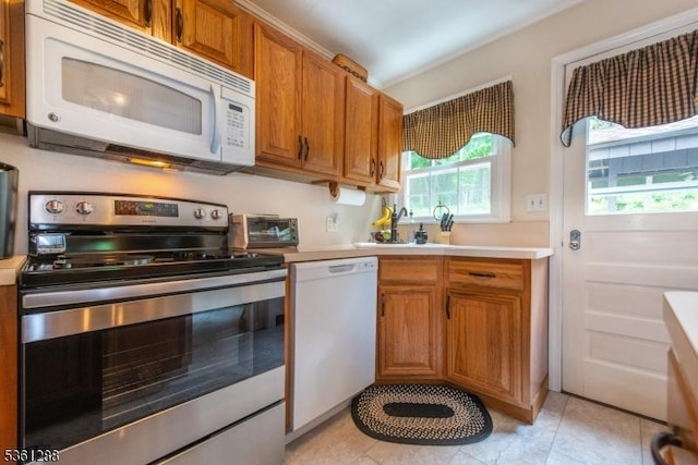 24 W Windy Bush Ln, Sparta Twp, NJ 07871 - kitchen featuring white appliances, light countertops, brown cabinetry, and light tile patterned flooring