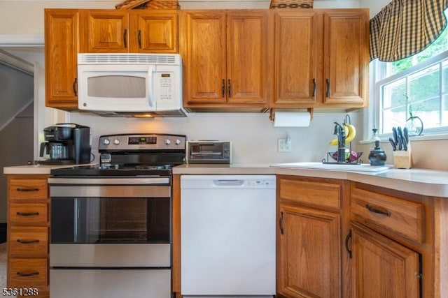 24 W Windy Bush Ln, Sparta Twp, NJ 07871 - kitchen with white appliances, light countertops, and brown cabinetry
